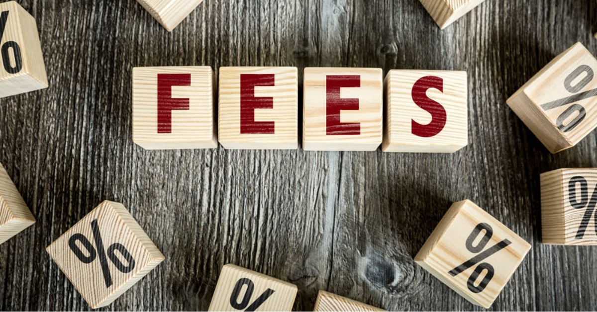 Wooden blocks spelling 'Fees' with percentage signs, symbolizing small business lawyer costs and fee structures.