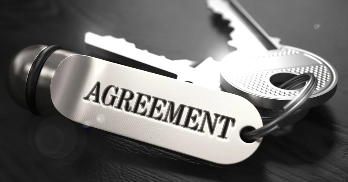 Close-up of a keychain with the word 'Agreement,' symbolizing the importance of contracts for small businesses.